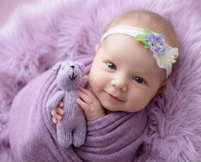 Older newborn baby wrapped in purple fabric at Sweetlife Photography North Lakes