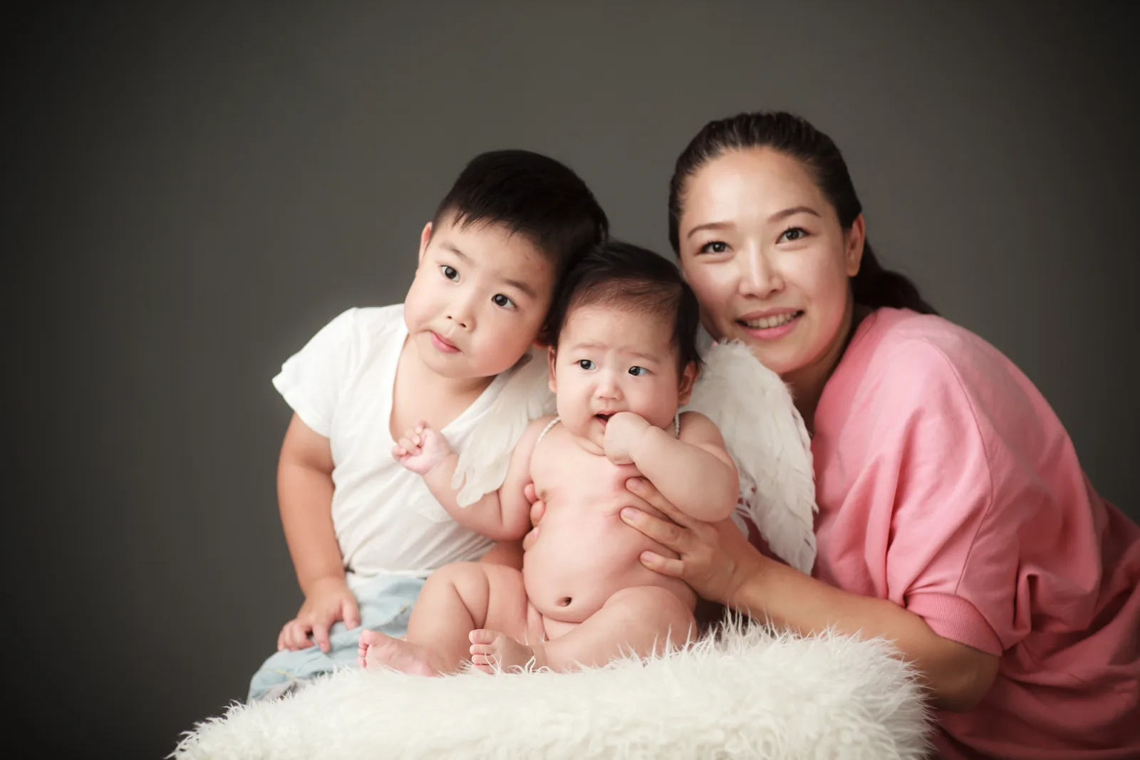 Newborn photographed with parents during a family portrait
